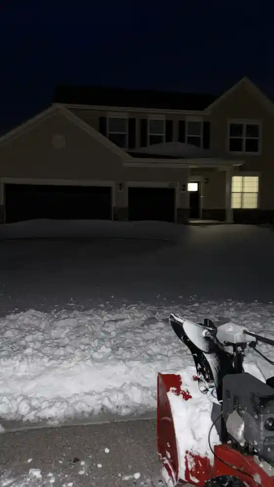 Snow-covered large driveway before clearing