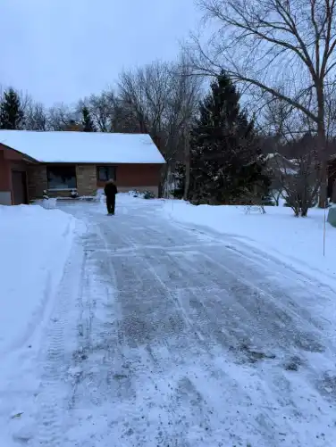 Driveway cleared through deep snow after snow removal